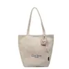 Bolsa de mano tipo tote simple de estilo coreano al por mayor para mujer 2025 Verano Nuevo Gran Capacidad Hombro Único Lona Versátil Bolso de Axila
