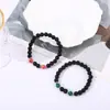 Accesorios de explosiones transfronterizas piedra volcánica negra mate de 8 mm piedra de ámbar fósil de viento pulseras de yoga para hombres y mujeres al por mayor