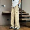 Pantalones cargo anchos de estilo retro para hombre, con bolsillos grandes, un diseño moderno y minimalista, colores lisos, un ajuste versátil y holgado, corte recto y cintura con cordón para uso casual.