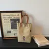 Bolso cubo de gran capacidad y estilo para mujer, perfecto para el trabajo y los desplazamientos en otoño e invierno, nueva colección 2026, bolso tote de lona bordada marrón