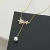 Cadena de clavícula elegante con incrustaciones de circonita y baño de oro real para mujer, collar de estrella de cinco puntas de alta calidad, cadena de suéter con borla de estrella exquisita