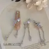 Nuevos accesorios de arte para uñas de alta gama: Adornos brillantes en forma de corazón de circón con incrustaciones de cobre, con borlas y cadenas largas, accesorios populares de verano