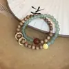 Nuevo Estilo Chino Piedra Natural Cuentas Redondas Sándalo Anillo Dorado Running Pulsera, Pulsera Elegante de Nicho, Elegante Pulsera de Moda de Nicho