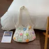 Bolsa de mano estilo dulce Shuai Mi Jia para mujer, Bolso de hombro con flor hueca Nuevo Verano 2026, Bolso de axila de moda