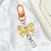 Llavero de lazo colorido con perlas, accesorios hechos a mano para fundas de teléfono, audífonos, bolsos y accesorios de ropa
