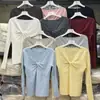 Suéter de punto de cuello redondo con mangas largas retorcidas de rayas verticales para otoño e invierno para mujer, principios de otoño, súper caliente, nicho, estilo único, top