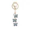 Llavero de Mariposa con Goteo de Aceite Versátil de Moda Llavero de Mariposa con Flor Colgante para Bolso de Mujer Regalos Pequeños Exquisitos Venta al por Mayor