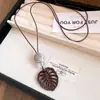 Colar com cordão de couro retrô e pingente oval, um acessório de moda luxuoso e estiloso, perfeito para combinar com suéteres, uma joia única e versátil para mulheres
