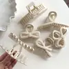 Elegante pasador estilo blanco arroz para mujer, pinza para el pelo de moño en la parte trasera de la cabeza, nuevo clip de tiburón 2025, pasador simple versátil, tocado
