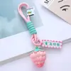 Llavero de cuerda de mano con colgante de fresa al por mayor, problemas y cosas buenas suceden, decoración de bolsa de regalo pequeña de fresa de moda en internet