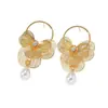 Nuevos pendientes largos de metal con diseño de flor hueca dorada, de lujo ligero de alta gama, transfronterizos, para mujer, joyería de moda y sencilla