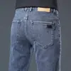 Jeans masculinos de alta qualidade para primavera e verão, corte reto, caimento slim, elástico, calça longa moderna de Guangzhou Xintang, estilo versátil de verão