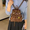 Mochila para mujer de uso diario 2026 linda nueva de dibujos animados invierno de un solo hombro estampado de leopardo estilo coreano y japonés gamuza bandolera bolso de mano de doble hombro
