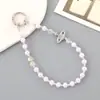 Ins Nuevo Colgante de Llavero con Lentejuelas y Lazo de Perlas para Funda de Teléfono Móvil Accesorios de Correa de Muñeca para Lanyard de Teléfono Móvil