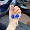 Llavero de lazo de moda con diamantes completos y cadena de perlas, un colgante lindo y brillante para bolsos, cadenas de teléfono y accesorios