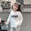 Camiseta de manga larga de algodón 100% para niñas con estampado de dibujos animados para primavera y otoño, adecuada para niños mayores y pequeños, camiseta básica versátil de cuello redondo estilo coreano
