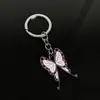 Llavero colgante de aleación de metal con diseño de mariposa Zhilang You Bean de Anime Ghost Extermination Blade que rodea el carbón. Comercio exterior.