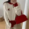 Elegante top de punto versátil de bloques de color con lazo, nuevo para otoño, suéter de cuello redondo con botones de madera estilo coreano de moda para mujer