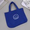 2023 nueva bolsa de lona para mujer, portátil, con cara sonriente, estilo universitario casual para estudiantes, trabajo, bandolera versátil