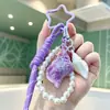 Colgante de concha curativa de moda, pulsera tejida, llavero de cadena de perlas, charm de bolso girly creativo, venta al por mayor