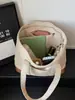 Bolsa de lona gruesa, simple, de gran capacidad 2026 nueva moda, bolso de mano y bolso de hombro versátil para ir al trabajo para niñas