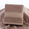 Toalla de seda de color puro dorado toalla facial de pareja lisa suave absorbente para adultos engrosada al por mayor toalla de algodón puro