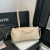 Bolsa texturizada para axila feminina, nova coleção primavera 2026, bolsa de ombro simples e estilosa para o dia a dia, bolsa de mão da moda para comércio exterior com detalhe de laço