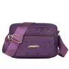 Bolsa Feminina Nova de Ombro Único para Primavera Crossbody Commute Bolsa para Celular e Moedas Tecido de Nylon Horizontal Quatro Zíperes Bolsa de Ombro Feminina