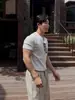 Camiseta Base Estilo Coreano Minimalista Asclo&Qiao, Moderna Camiseta de Manga Corta con Cuello Henley, Top Transpirable Casual de Rayas Verticales