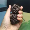 Madera negra, molino de viento de madera, pelota de ejercicio de madera maciza, pelota de mano de madera para jugar, pelota de masaje para la palma de la mano, talla de madera de un durián