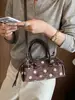 Bolso de axila de lunares estilo coreano de nicho para mujer, nuevo de moda otoño 2026, versátil, de alta gama, para ir al trabajo, de hombro y cruzado