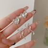 Pendientes minimalistas de plata Viento Frío Amor Inteligente para Mujer, Aguja de Plata, Nicho, Exquisitos, Huecos, Lazo, Pendientes de Alta Gama