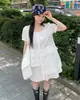 Vestido camisa asimétrico de diseño de cuello redondo chic coreano de nicho 2026
