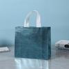 Bolsa no tejida bolsa de regalo transfronteriza en stock suministro precio grande excelente revestida aluminizada bolsa de compras láser
