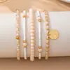 Conjunto de pulseiras boêmias transfronteiriças para férias, com múltiplas camadas empilhadas e pingentes simples de contas de vidro em disco elástico