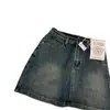 Mini saia jeans de cintura alta estilo retrô de Hong Kong para mulheres, novo modelo 2026, anti-exposição, corte A, justa ao quadril, emagrecedora, versátil, moderna, cor sólida