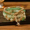 Conjunto de pulseiras multicamadas no atacado, conjunto de quatro peças de joias artesanais em vidro com contas, conjunto de pulseiras elásticas, acessório de mão com suporte de flor de ferro