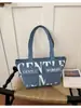 Estilo europeo y americano transfronterizo, directamente desde la fábrica de origen: bolsa de lona nueva con letras estampadas, adecuada para que los estudiantes la usen en clase, para ir de compras, o como bolso de hombro o bolso de axila