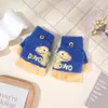 Guantes de dedo medio para niños otoño e invierno niños medio dedo cálidos lindos estudiantes de primaria escritura guantes de punto de doble propósito al por mayor