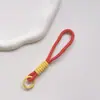 Correa de Muñeca Trenzada Estilo Ins Lanyard Nudado Cuerda Corta de Silicona Colgante Antiperdida para Teléfono Dopamina