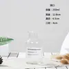 Venta al por mayor Estilo Lujo Ligero Jarrón de Vidrio Nórdico Muebles para el Hogar Accesorios Creativos Adornos Botella Transparente para Hidroponía Jarrón de Botella Marrón