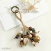 Pingente de Bolsa de Contas de Cerâmica de Jingdezhen Chaveiro Artístico Tecido à Mão de Sementes de Bodhi Ornamento de Estilo Floresta de Nicho
