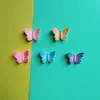 Accesorios de mariposa coloridos simulados personalizados al por mayor para ropa hecha a mano para bricolaje, pinzas para el cabello, cajas de almacenamiento, zuecos, bolsos y fundas para auriculares