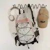 Mochila com cordão e estampa de coração em patchwork branco em um estilo doce e descolado para meninas, jovial e vibrante, adequada para estudantes e passeios