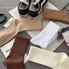 Calcetines Zhuji para mujer de caña larga otoño e invierno ins moda japonesa alto valor en color color sólido calcetines de canalé para niños al por mayor