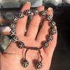 Venta al por mayor de fábrica Pulsera de joyería Xizang Tianzhu con cuentas redondas negras y blancas, patrón de herradura, pulpa envuelta, patrón desgastado, cuerda trenzada A