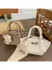 Bolsa Única com Textura Pequena Tote Bag para Mulheres 2026 Estilo Novo da Primavera Bolsa de Cesta Simples Ombro Transversal Bolsa Asa
