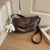 Bolso bandolera minimalista de nicho retro tipo empanada, nuevo y moderno de moda para principios de otoño de 2026, bolso de hombro de color liso para el trabajo y los desplazamientos