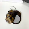 Nuevo Llavero Peine Espejo Multifuncional Transfronterizo, Colgante de Llave de Bolso Moderno y Versátil, Peine Espejo de Maquillaje Portátil