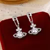 Flash West Diadema Flash Zirconia Pendientes Saturno para Mujer Pendientes Refinados de Alta Gama Temperamento de Socialité Accesorios para Orejas de Lujo Ligero